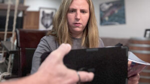 A client concentrates on a letter board